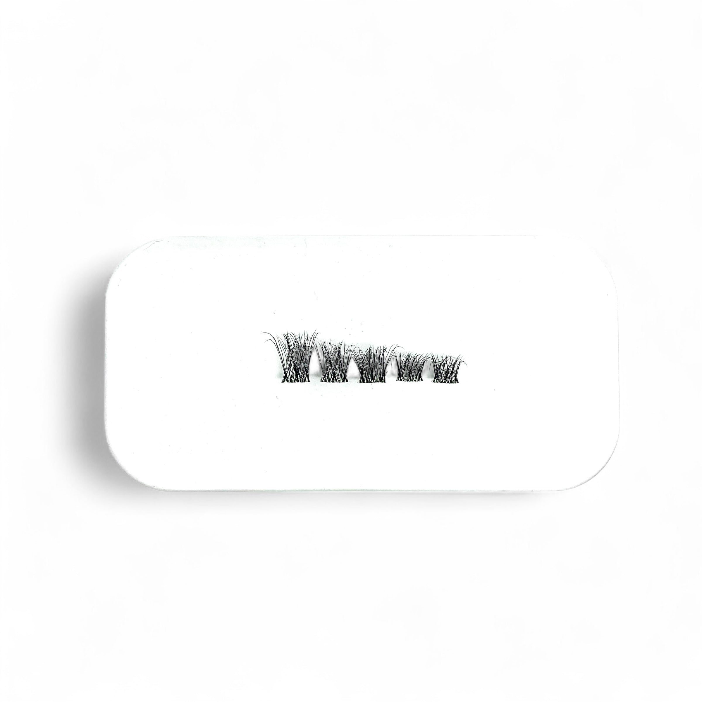 Set of false eyelashes on a clear lash mapping pad