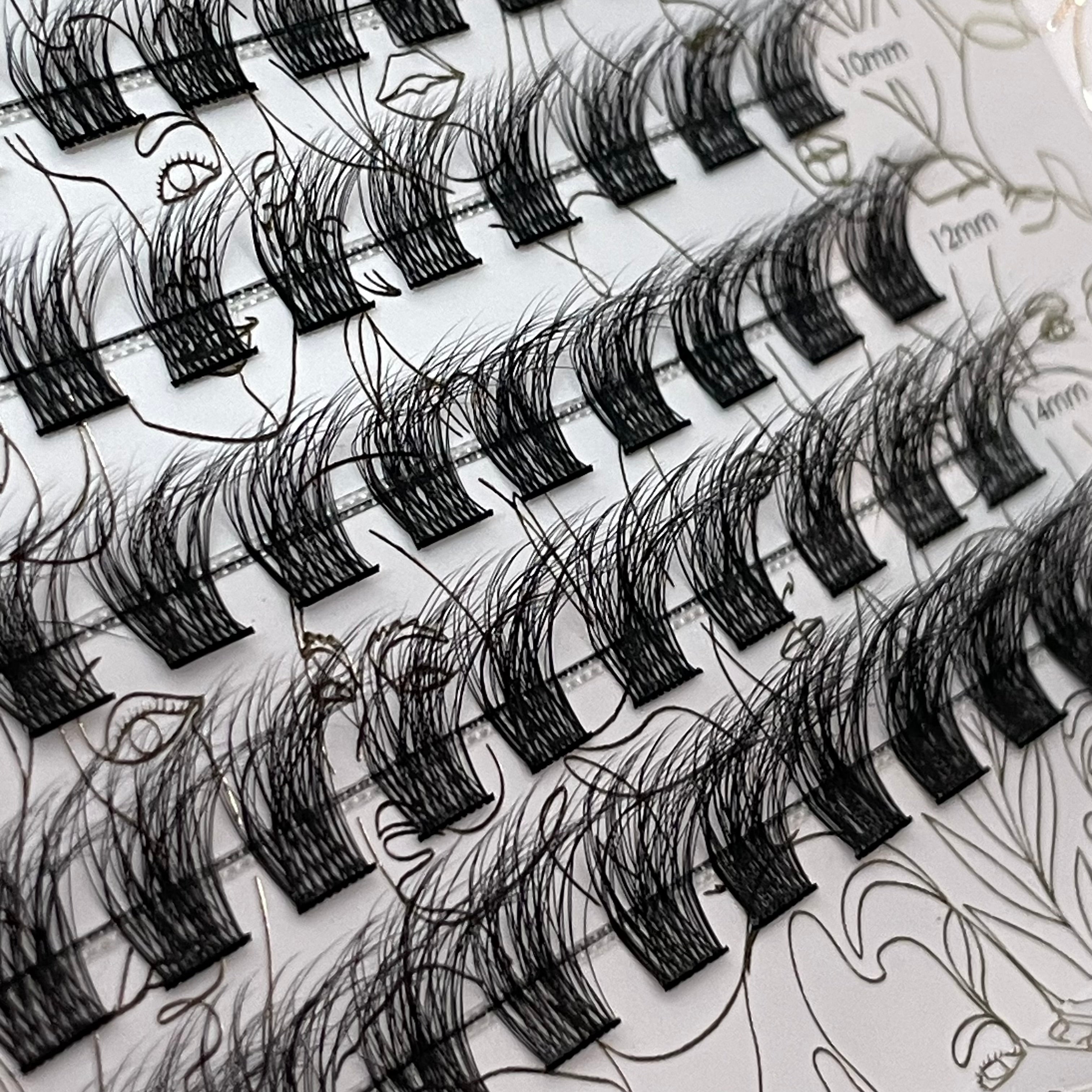 Close-up angled view of iLash Mafia BUSSIN DIY lash extensions featuring wispy cluster lashes, soft volume, lightweight fullness, and fluffy texture. Perfect for creating customizable Doll Eye and Cat Eye lash styles at home.