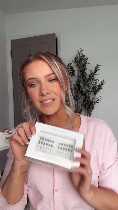 A step-by-step close-up of a woman applying individual lash clusters using a DIY eyelash extension kit and sealing them in place.